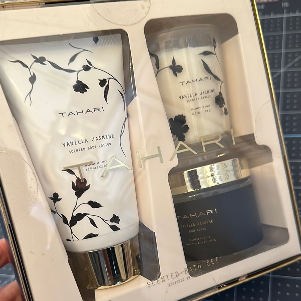 Tahari vanilla, jasmine scented body lotion, a candle and body scrub